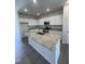 Modern kitchen with granite countertops, a spacious island, stainless steel appliances, and white cabinetry at 322 Deodora Ln, Cameron, NC 28326