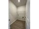 Conveniently located laundry room with wire shelving and durable wood-look floors at 322 Deodora Ln, Cameron, NC 28326