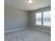 Carpeted bedroom with two large windows that allow plenty of natural light to enter the room at 33 Brooklynn Trail # 181, Angier, NC 27501