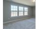 Carpeted bedroom with plenty of natural light coming in through the large windows overlooking the backyard at 33 Brooklynn Trail # 181, Angier, NC 27501