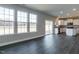 Open-concept living space with large windows and sliding glass doors, adjacent to kitchen at 33 Brooklynn Trail # 181, Angier, NC 27501