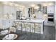 This kitchen features white cabinets, stainless steel appliances, an island with barstool seating, and modern lighting at 3725 Lebrun Path # 151 Lassen Fh, Fuquay Varina, NC 27526