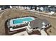 Aerial view of the community pool featuring lounge chairs, a pool house, and surrounding landscaped grounds at 3725 Lebrun Path # 151 Lassen Fh, Fuquay Varina, NC 27526