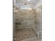 A large walk-in shower with a glass door, tiled walls, dual shower heads, a shower bench, and a window at 3725 Lebrun Path # 151 Lassen Fh, Fuquay Varina, NC 27526