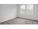 Well-lit bedroom with carpet and two windows offering views of the outdoors at 3918 Well Fleet Dr, Fuquay Varina, NC 27526