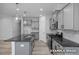 Well-lit kitchen with gray cabinets, granite countertops, stainless steel appliances, and a spacious island at 3918 Well Fleet Dr, Fuquay Varina, NC 27526