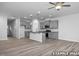 Bright, open kitchen and living area featuring gray cabinets, granite countertops, and wood flooring at 3918 Well Fleet Dr, Fuquay Varina, NC 27526