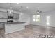 An open concept kitchen with island, granite countertops, stainless appliances and eat-in dining area at 3918 Well Fleet Dr, Fuquay Varina, NC 27526