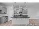 Elegant kitchen with granite island, modern lighting, and stainless steel appliances at 3918 Well Fleet Dr, Fuquay Varina, NC 27526