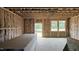 Spacious living room featuring framed walls, insulation, and ample natural light from large windows at 3918 Well Fleet Dr, Fuquay Varina, NC 27526