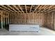 Living room featuring exposed beams, insulation, and a stack of drywall ready for finishing at 3918 Well Fleet Dr, Fuquay Varina, NC 27526