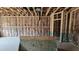 Unfinished room with visible framing, insulation, and space for customization at 3918 Well Fleet Dr, Fuquay Varina, NC 27526