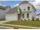 Charming home with an attached garage, manicured lawn, and fresh landscaping with a young tree at 392 Peach Grove Way, Lillington, NC 27546