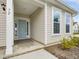 Close up on light blue front door with sidelight windows on a charming home at 392 Peach Grove Way, Lillington, NC 27546