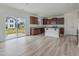 Open kitchen with dark wood cabinets, granite countertops, and a large sliding glass door to the backyard at 392 Peach Grove Way, Lillington, NC 27546