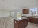 Bright kitchen with a granite island, dark wood cabinets, and open floor plan at 392 Peach Grove Way, Lillington, NC 27546