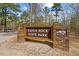 Stone and wood sign reading: Raven Rock State Park, North Carolina State Parks at 392 Peach Grove Way, Lillington, NC 27546