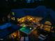 A scenic aerial view showcases the backyard, highlighting the pool, spa, patio, and outdoor cabana at 403 Granville Rd, Chapel Hill, NC 27514