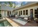 Spacious backyard deck with pool, outdoor furniture, and a charming outdoor fireplace at 403 Granville Rd, Chapel Hill, NC 27514