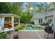 Spacious backyard deck with pool, cabana, outdoor furniture, and a grill at 403 Granville Rd, Chapel Hill, NC 27514