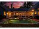 Expansive backyard with a luxurious pool and spa, surrounded by lush landscaping and an entertainment area at 403 Granville Rd, Chapel Hill, NC 27514