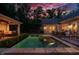 Beautiful backyard pool with integrated hot tub next to an outdoor kitchen and dining area at 403 Granville Rd, Chapel Hill, NC 27514
