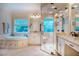 Bright bathroom with soaking tub, glass shower, granite vanity, and natural light from a window at 403 Granville Rd, Chapel Hill, NC 27514
