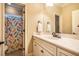 Bathroom featuring a white marble vanity, an oversized mirror, and a shower with a mermaid shower curtain at 403 Granville Rd, Chapel Hill, NC 27514