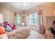 Charming bedroom with floral bedding, large windows with pink curtains, and soft, carpeted floors at 403 Granville Rd, Chapel Hill, NC 27514