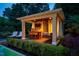 Outdoor cabana features bar with seating, a TV, curtains for privacy and a swinging sofa. Great for outdoor entertaining at 403 Granville Rd, Chapel Hill, NC 27514