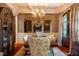 Elegant dining room featuring a large mirror, coffered ceiling, and view into the library at 403 Granville Rd, Chapel Hill, NC 27514