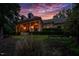 Stately home exterior showcasing manicured lawn, elegant columns, and inviting entrance at sunset at 403 Granville Rd, Chapel Hill, NC 27514