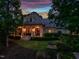 Elegant home with a covered front porch supported by grand columns, set amidst a lush, green lawn at 403 Granville Rd, Chapel Hill, NC 27514