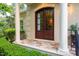 Inviting front entrance with double wood doors, lantern sconces and elegant porch setting at 403 Granville Rd, Chapel Hill, NC 27514