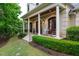 Inviting front entrance with double wood doors, lantern sconces and elegant porch setting at 403 Granville Rd, Chapel Hill, NC 27514