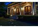 Welcoming front porch with large columns, comfortable seating, and manicured landscaping at 403 Granville Rd, Chapel Hill, NC 27514