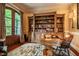 Charming home office with built-in bookshelves, a desk, and french doors to the outside at 403 Granville Rd, Chapel Hill, NC 27514