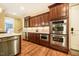 Kitchen with stainless steel double ovens, granite countertops, custom cabinetry, and hardwood flooring at 403 Granville Rd, Chapel Hill, NC 27514