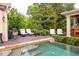 Lounge poolside on the stylish outdoor deck with plush chairs, barbecue grill and a beautifully landscaped yard at 403 Granville Rd, Chapel Hill, NC 27514