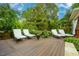 Inviting outdoor deck with elegant lounge chairs surrounded by lush, landscaped greenery at 403 Granville Rd, Chapel Hill, NC 27514