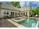 Gorgeous backyard showcasing a pool, hot tub, covered patio and an outdoor seating and dining area at 403 Granville Rd, Chapel Hill, NC 27514
