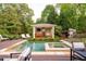 A beautiful backyard pool and hot tub with an outdoor cabana, a perfect spot for relaxation and entertaining at 403 Granville Rd, Chapel Hill, NC 27514