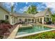 Beautiful backyard with a pool, a hot tub, patio, and outdoor dining/seating areas under a blue sky at 403 Granville Rd, Chapel Hill, NC 27514