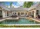 Stunning backyard featuring a swimming pool, hot tub, expansive patio, and outdoor seating and dining at 403 Granville Rd, Chapel Hill, NC 27514