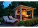 Relaxing poolside cabana with a swing, TV, bar, and two lounge chairs; perfect for entertaining at 403 Granville Rd, Chapel Hill, NC 27514