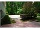 Brick patio leads to lush greenery with a concrete slab offering many opportunities for outdoor enjoyment at 4113 Oak Park Rd, Raleigh, NC 27612