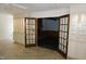 Basement area with custom cabinets, tiled floor and glass paneled French doors to another room at 4113 Oak Park Rd, Raleigh, NC 27612