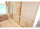 Bright bathroom with a glass enclosed soaking tub and golden fixtures at 4113 Oak Park Rd, Raleigh, NC 27612