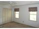 A neutral bedroom with a ceiling fan, closet and two light-filled windows at 4113 Oak Park Rd, Raleigh, NC 27612