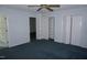 Carpeted bedroom with multiple closets and a connecting door to another room at 4113 Oak Park Rd, Raleigh, NC 27612